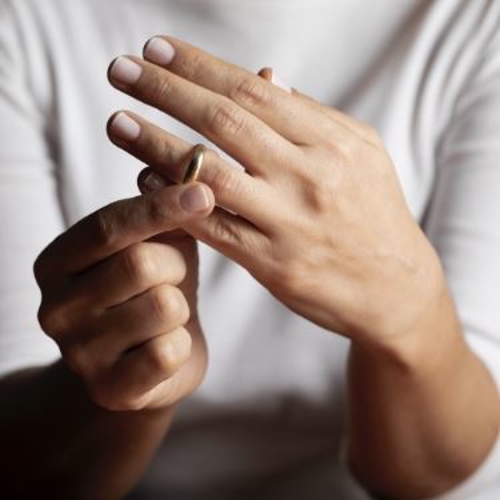 A person putting on a wedding ring