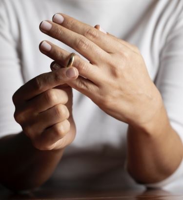 A person putting on a wedding ring