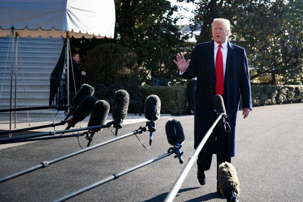 Trump standing in front of microphones.